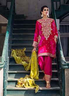 Febric: Velvet & Raw Silk Work: Hand worked gold zardozi Fuchsia velvet Kashmiri phiran outfit with elaborate zardozi gala and pockets. Peridot velvet doshala lends a contrasting depth to the ensemble. "It is a 3 piece outfit." Add Ons : Pant PKR 22,000 /- Dupatta PKR 45,000/- Note: The current price is of shirt only. To add dupatta and pants in the order, please add them from the option given above. Kashmiri Phiran, 3 Piece Outfit, Latest Bridal Dresses, Pakistani Wedding Outfits, Pakistani Bridal Dresses, Pakistani Bridal Wear, Boutique Dress Designs