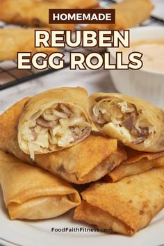 homemade reuben egg rolls on a white plate with dipping sauce in the background and text overlay reading homemade reuben egg rolls