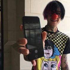 a person holding up a cell phone and clown nose