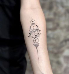 a woman's arm with a lotus tattoo on it