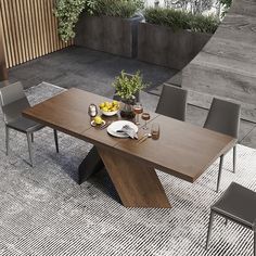 a dining table with chairs around it on a rug in front of a wooden wall