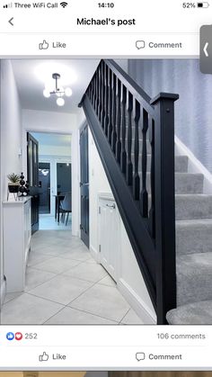 a staircase with black railing and white walls