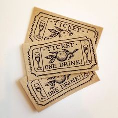 two tickets with the words ticket one drink and one wine glass on them are sitting next to each other