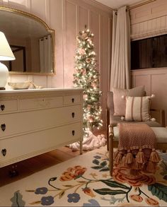 a living room with a christmas tree in the corner and a chair next to it