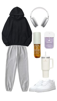 a black hoodie, sweatpants, headphones and coffee mug