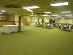 an empty banquet room with tables and chairs