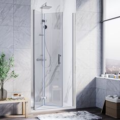 a bathroom with a walk in shower next to a window and rug on the floor