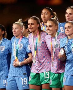 the u s women's soccer team poses for a group photo with their medals