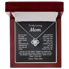 a wooden frame with a necklace and poem on it