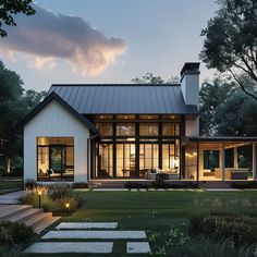 a modern house is lit up at night