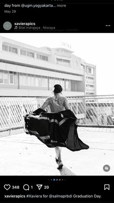 a woman is walking down the street with her dress blowing in the wind