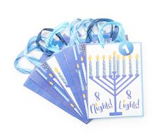 four hanukkah cards with blue ribbons and a ribbon around the card that says eight nights of light