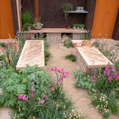 two wooden benches sitting in the middle of a garden