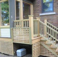 a wooden staircase leading up to a brick building