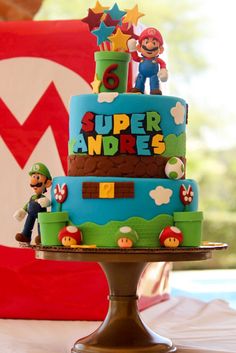 a birthday cake with mario and luigi on top