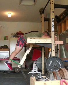 a man on a pull up bar in a garage