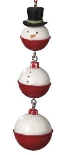 three white and red ornaments with a black top hat on one ornament in the shape of a snowman