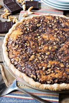 a chocolate pecan pie sitting on top of a wooden table