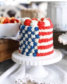 an american flag cake on a white pedestal