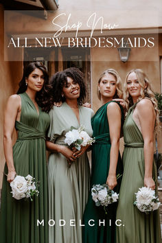 four bridesmaids in green dresses posing for the camera with white flowers and greenery