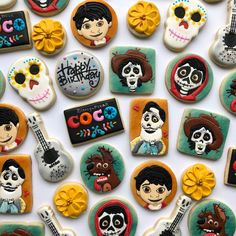 many decorated cookies are arranged in the shape of guitars and skeletons with faces on them