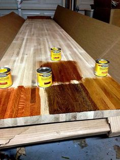 several cans of paint sitting on top of a wooden table