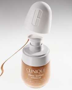 an open bottle of clinique's even better foundation cream on a white background