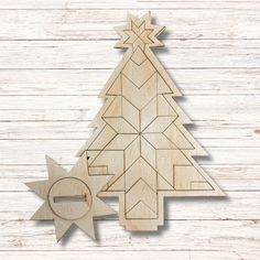 a wooden christmas tree cutout with an ornament in the shape of a star