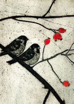 two birds sitting on a tree branch with red berries