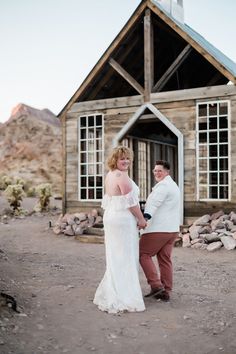 a man and woman standing in front of a building