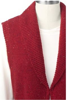 a red sweater vest on a mannequin