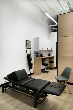 Hella Design Studio | Calgary Interior Design | Massage & Physio Studio | We used black equipment and treatment tables in the physio space to keep things cohesive and minimal. New flooring, new paint, and some added storage, and you've got yourself a minimal, functional, bright and open treatment space. 📷: @heymjay Massage Interior Design, Chiropractic Office Design, Massage Room Design