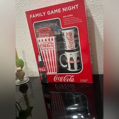 an unopened coca - cola family game night box is displayed on a table