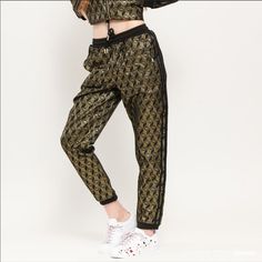 1970 Honor Its 50th Anniversary In These Track Pants, With A Metallic Monogram Design Featuring The Shell Toe Specifications Regular Fit Drawcord On Elastic Waist 85% Polyester 15% Metallized Fiber Jacquard Track Pants With Metallic-Gold Thread Side Welt Pockets Ribbed Cuffs Imported Black / Gold Metallic Washing Instructions Do Not Bleach Do Not Tumble Dry Do Not Dry Clean Do Not Iron Machine Wash Cold Delicate Cycle Use Mild Detergent Only Wash Separately Wash Inside Washing Bag Retro Black Bottoms For Night Out, Adidas Fitted Bottoms For Streetwear, Adidas Fitted Pants For Streetwear, Adidas Fitted Sweatpants, Adidas Fitted Sweatpants For Spring, Paris Living, Adidas Jogging Pants, Adidas Soccer Pants, Red Joggers