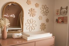 a baby's room decorated in pink and gold