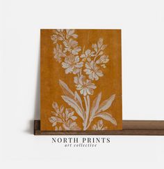 a wooden shelf with a painting on it that says north print's art collective