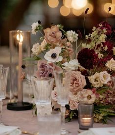 a table topped with lots of different types of flowers