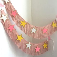 pink, yellow and white stars hanging from a string