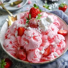 a bowl filled with ice cream and strawberries