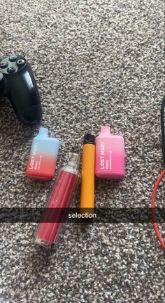 two batteries and a game controller on the ground