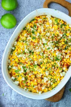 a white casserole dish filled with corn and cheese