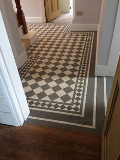 a hallway with black and white checkered flooring