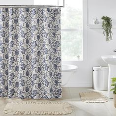 a bathroom with a shower curtain and rug