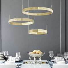 a dining room table with plates, glasses and silverware hanging from it's ceiling