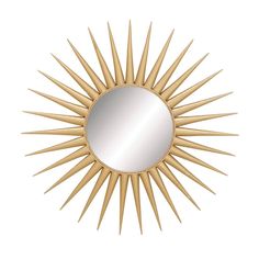 a gold sun mirror on a white wall