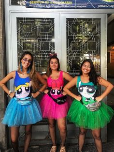 three girls dressed up in costumes standing next to each other