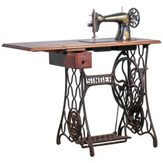 an old sewing machine is sitting on top of a wooden table with wheels attached to it