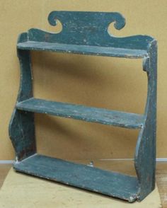 an old blue wooden shelf with two shelves