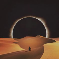 a man standing in the middle of a desert under a solar eclipse with his shadow on the ground