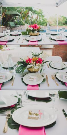 the table is set with white plates and pink napkins